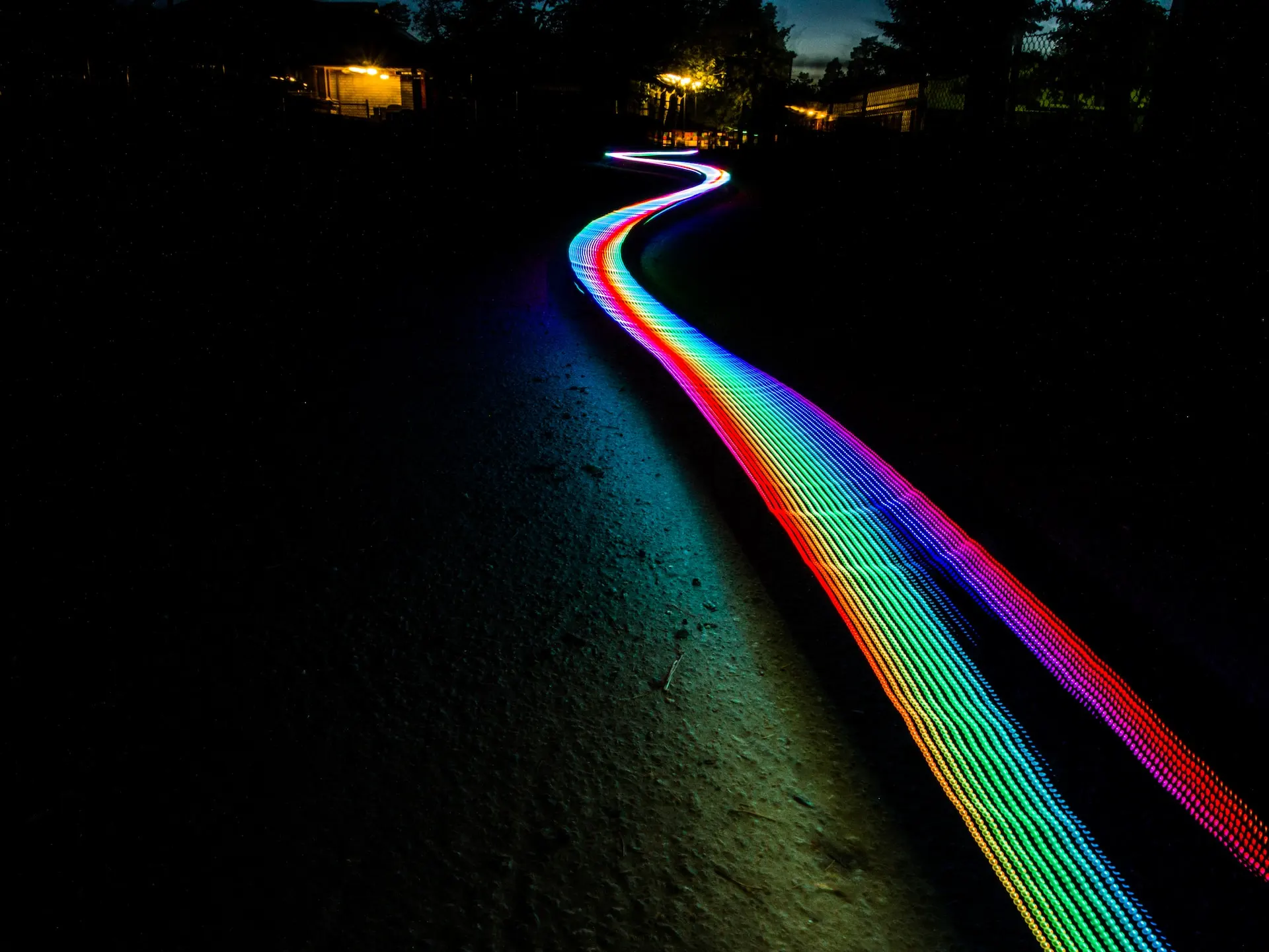 Rainbow smudge going through a dark rural place